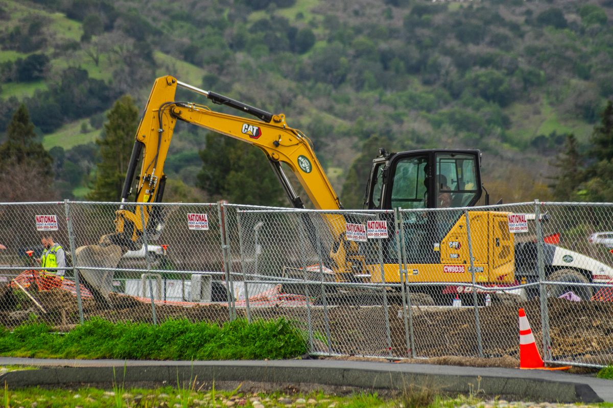Yellow tracked excavator on a construction site