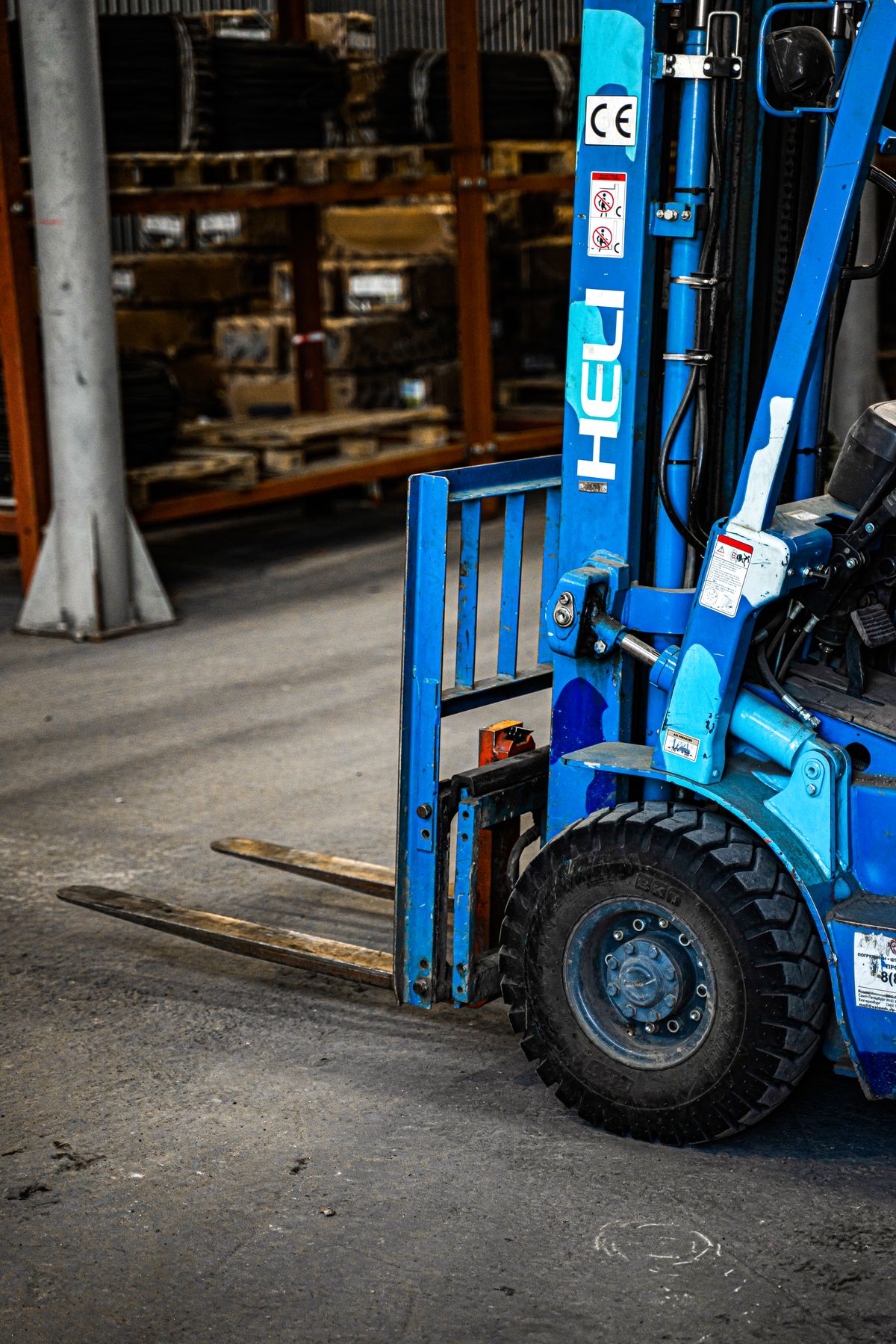 Forklift parked inside a working warehouse